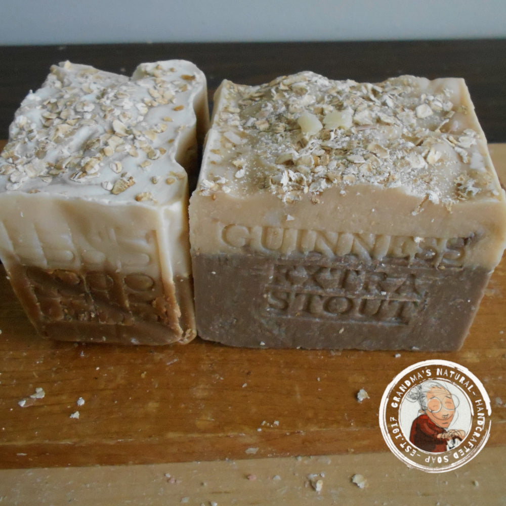  Guinness beer soap, features layers of dark brown, light brown, and beige with "STOUT GUINNESS" embossed on it. The rough-textured soap includes oatmeal pieces embedded in the beige layer at the bottom and helps soften your skin.