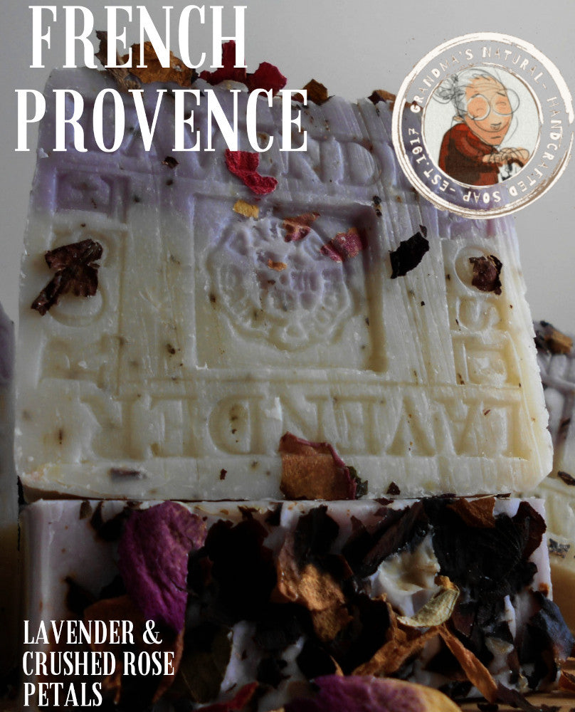  Handmade natural soap bars infused with Provence French lavender, featuring pieces of dried flowers embedded on the surface. The soap is a mix of white and light purple, with the word "LAVENDER" visibly embossed on each bar.