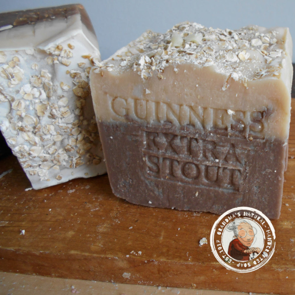  Guinness beer soap, features layers of dark brown, light brown, and beige with "STOUT GUINNESS" embossed on it. The rough-textured soap includes oatmeal pieces embedded in the beige layer at the bottom and helps soften your skin.